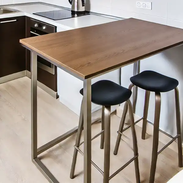 A counter height kitchen table in a small kitchen, paired with bar stools